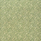 A sheet of green wrapping paper with a dense cream floral and vine pattern, shown partially unrolled on a white background. 
