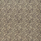 A sheet of dark aubergine wrapping paper with a dense cream floral and vine pattern