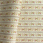 A close-up of patterned wrapping paper with horizontal stripes and a repeating floral vine motif in muted green, pink, and brown on an off-white background. 