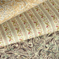 a close up of three sheets of patterned wrapping paper, top and bottom sheets are marbled designs is sandy and brown colours. Middle sheet is a stripe with a floral motif