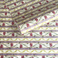 A close-up of a patterned wrapping paper featuring horizontal lavender and cream stripes with pink flowers, green stems, and olive-green wavy lines.