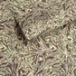 a printed marbled wrapping paper sheet with swirling brown, beige, muted green, and small yellow accents. By The Kensington Paperie brand