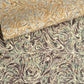 a printed marbled wrapping paper sheet with swirling brown, beige, muted green, and small yellow accents. By The Kensington Paperie brand. Pictured alongside a version in yellow