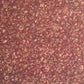 A close-up of a marbled patterned wrapping paper with swirling abstract swirls in reddish brown, rust, beige, and muted gold tones.