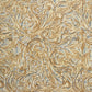 a sheet of printed marbled wrapping paper by The Kensington Paperie with a marbled swirl pattern in mustard, grey and cream