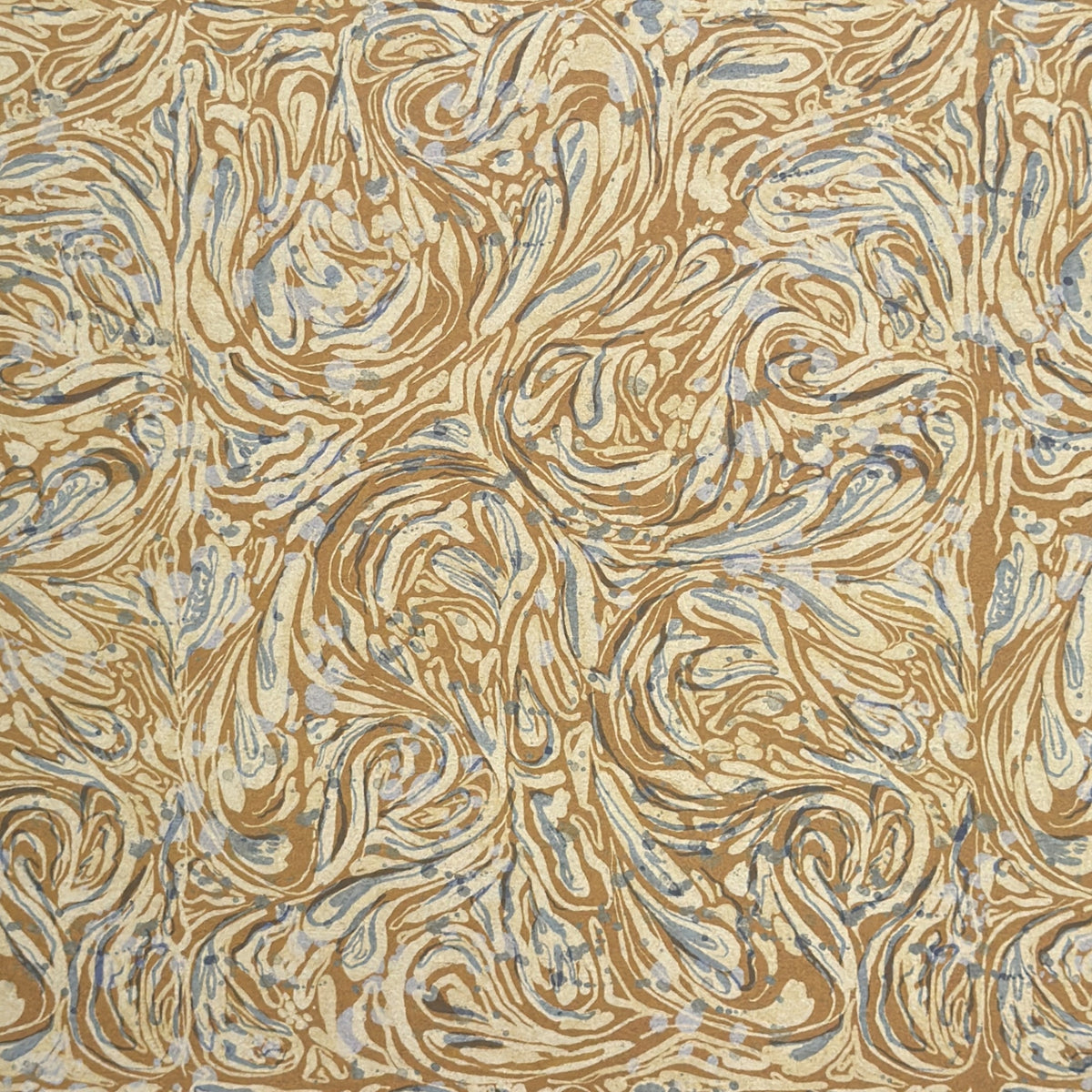 a sheet of printed marbled wrapping paper by The Kensington Paperie with a marbled swirl pattern in mustard, grey and cream