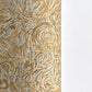a sheet of printed marbled wrapping paper by The Kensington Paperie with a marbled swirl pattern in mustard, grey and cream