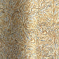 a sheet of printed marbled wrapping paper by The Kensington Paperie with a marbled swirl pattern in mustard, grey and cream
