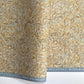 a sheet of printed marbled wrapping paper by The Kensington Paperie with a marbled swirl pattern in mustard, grey and cream