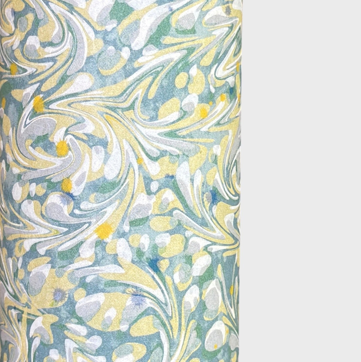 a sheet of printed marbled paper with a marble pattern in sage green, butter yellow, soft grey and white. 