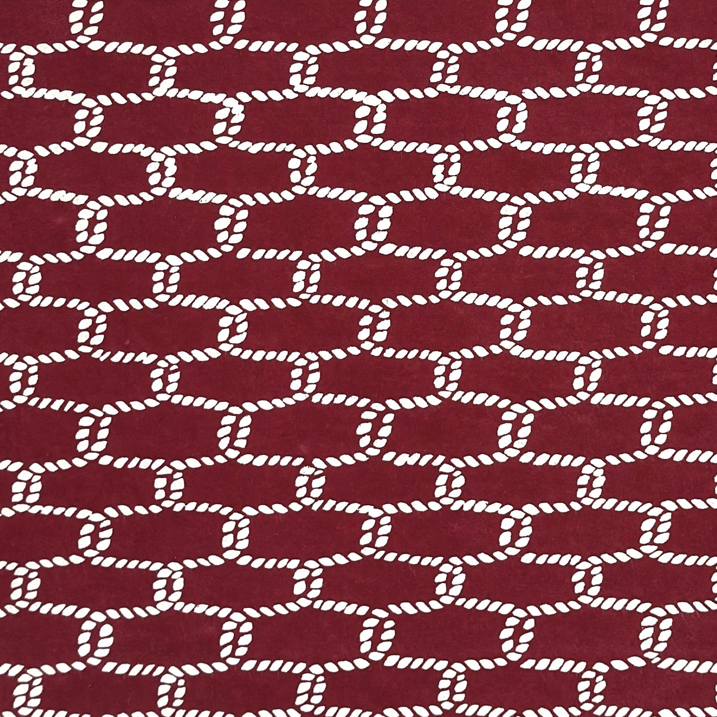 vintage katazome-shi stencil-dyed small papers from Japan. burgundy paper with a cream link pattern. 