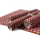 vintage katazome-shi stencil-dyed small papers from Japan. Cream paper with terracotta circles pattern. Pictured rolled.