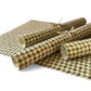 vintage katazome-shi stencil-dyed small papers from Japan. Cream paper with olive and red lattice pattern. Pictured rolled.