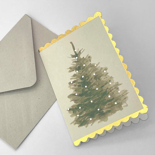 small card with a painting of a christmas tree with white lights on a cream background. The christmas card has a gold foiled scalloped edge. By Wanderlust. With envelope