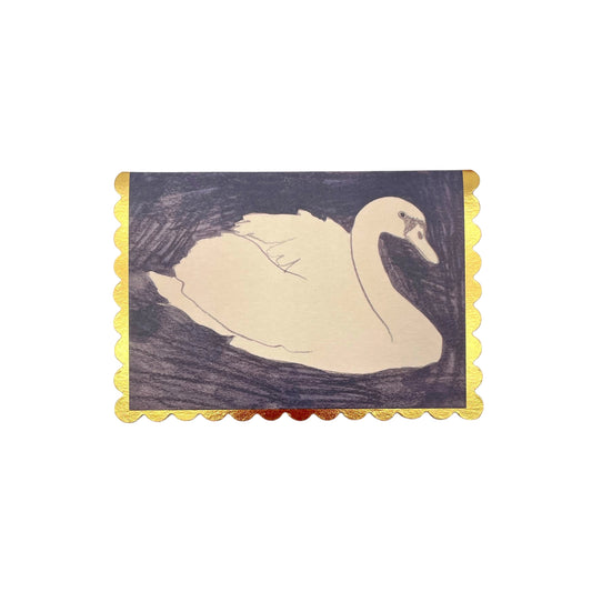 small rectangular greetings card with an image of a white swan on a black background. the card has a gold foil scalloped edge. By Wanderlust
