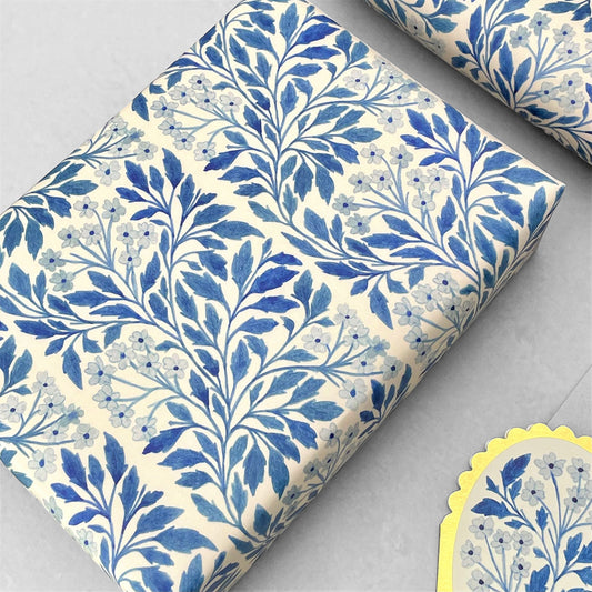 patterned paper / gift wrap with a delicate floral repeat pattern in blue on a ivory background. By Wanderlust