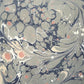 Printed marbled wrapping paper in dusty blue, grey and pink. 