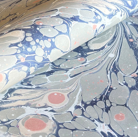 Printed marbled wrapping paper in dusty blue, grey and pink. 