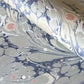 Printed marbled wrapping paper in dusty blue, grey and pink. 
