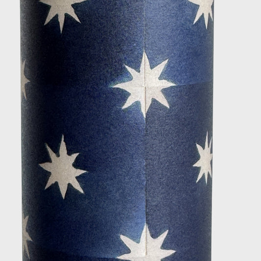 chequered navy blue with cream stars patterned wrapping paper. Close up 