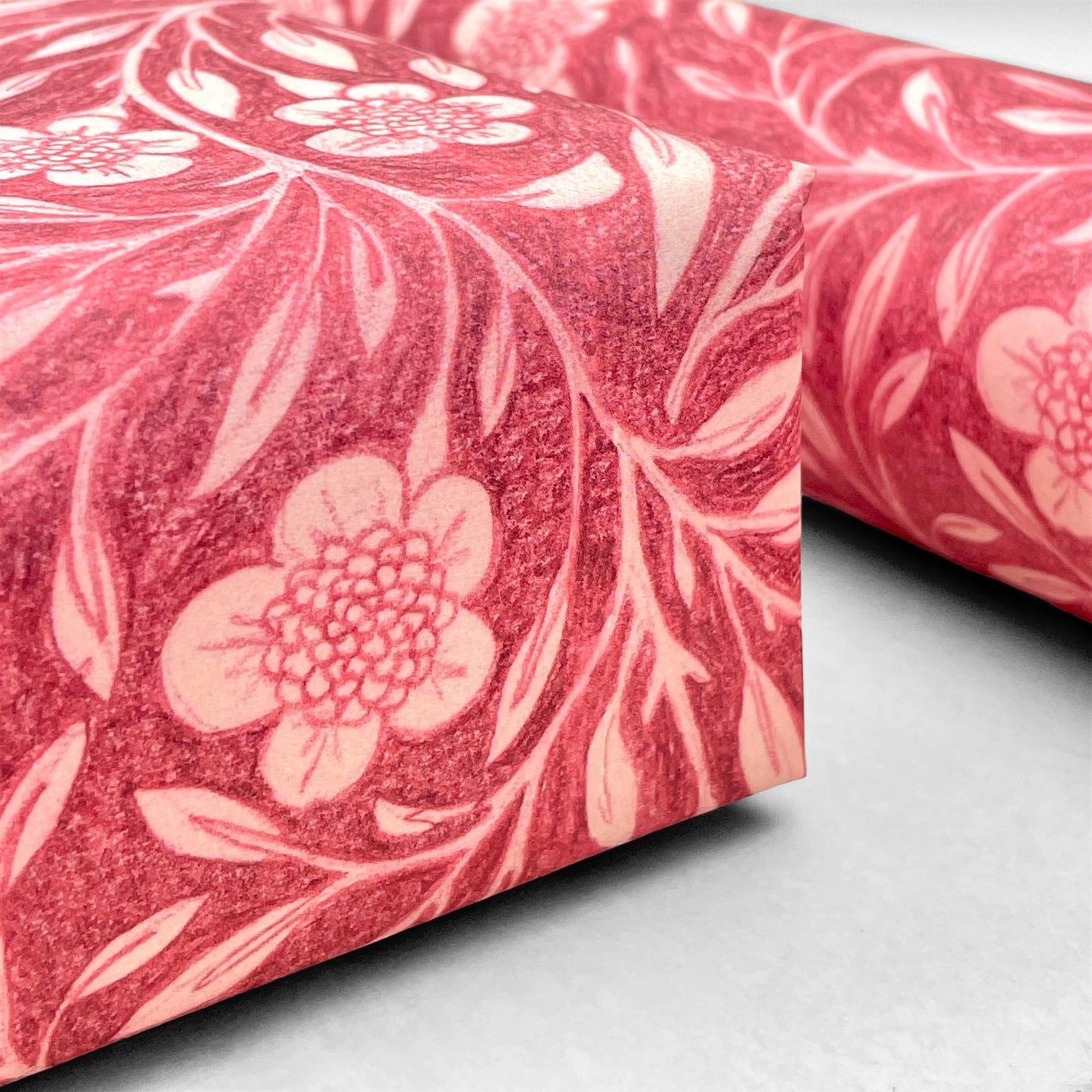 patterned paper / gift wrap with a delicate floral pattern in deep pink and white by Wanderlust