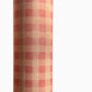 Checkered pattern wrapping paper with pink and beige squares. Close up
