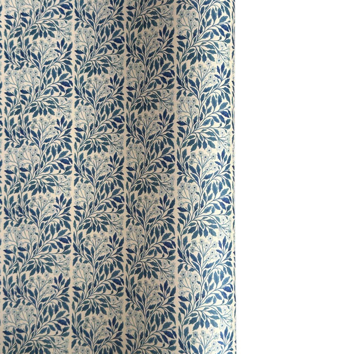 patterned paper / gift wrap with a delicate floral repeat pattern in blue on a ivory background.  By Wanderlust