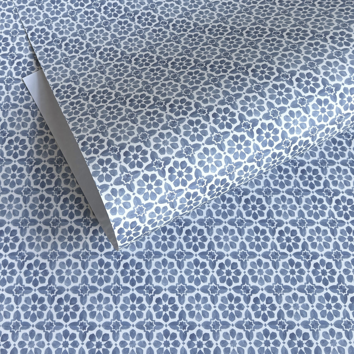 patterned paper / gift wrap with a blue and white tile design. By Wanderlust