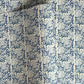 patterned paper / gift wrap with a delicate floral repeat pattern in blue on a ivory background.  By Wanderlust