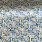 patterned paper / gift wrap with a delicate floral repeat pattern in blue on a ivory background.  By Wanderlust