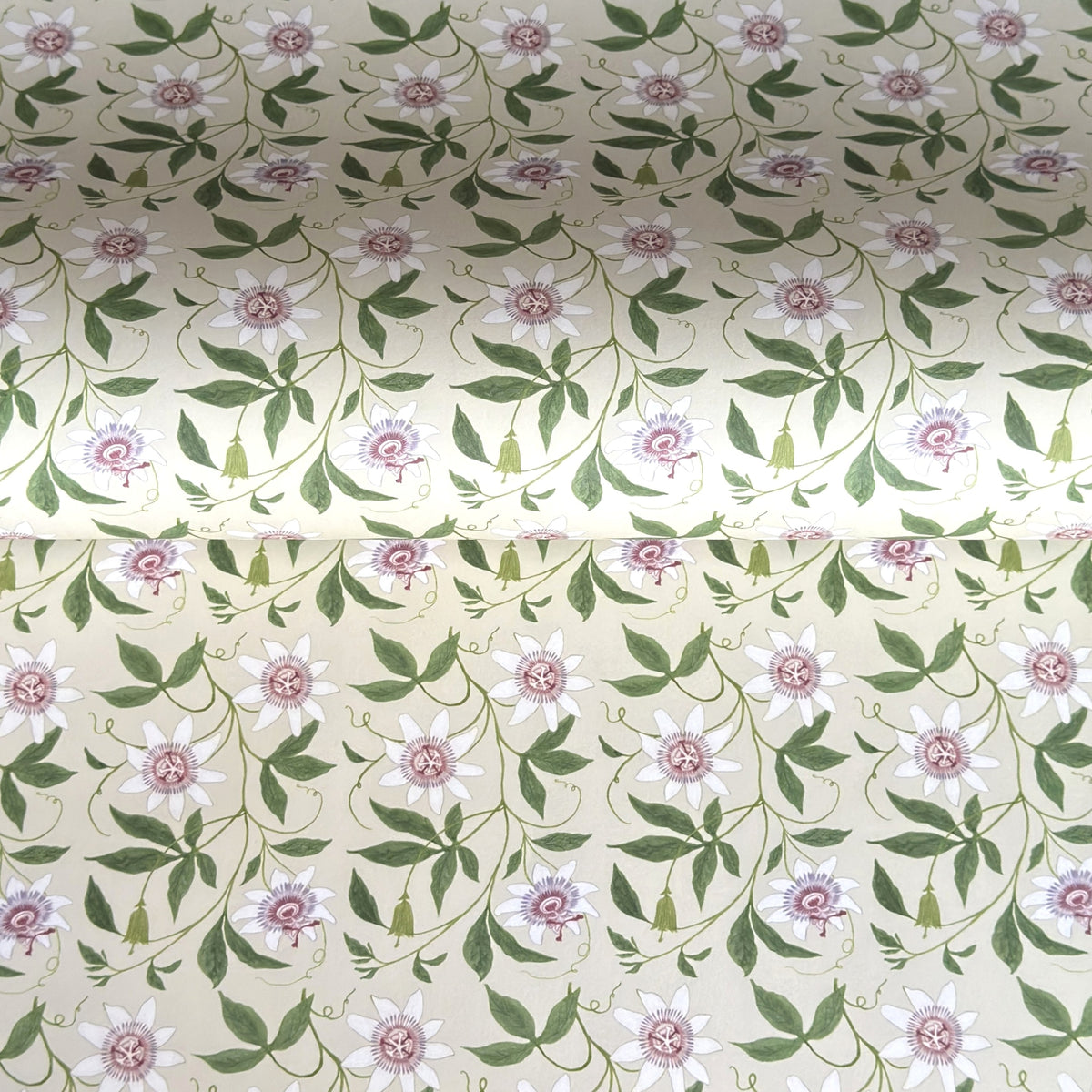 floral wrapping paper with pink passion flowers, green leaves on a cream background  