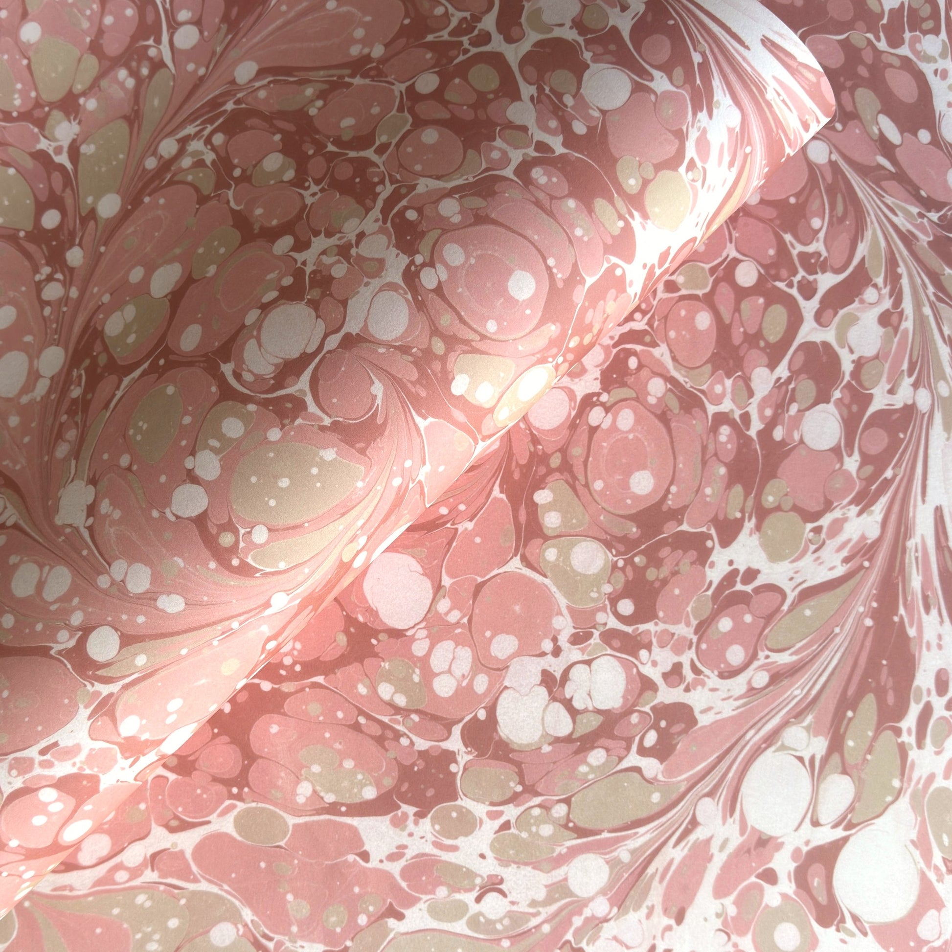 Printed marbled wrapping paper in dusty pink, taupe and white. 