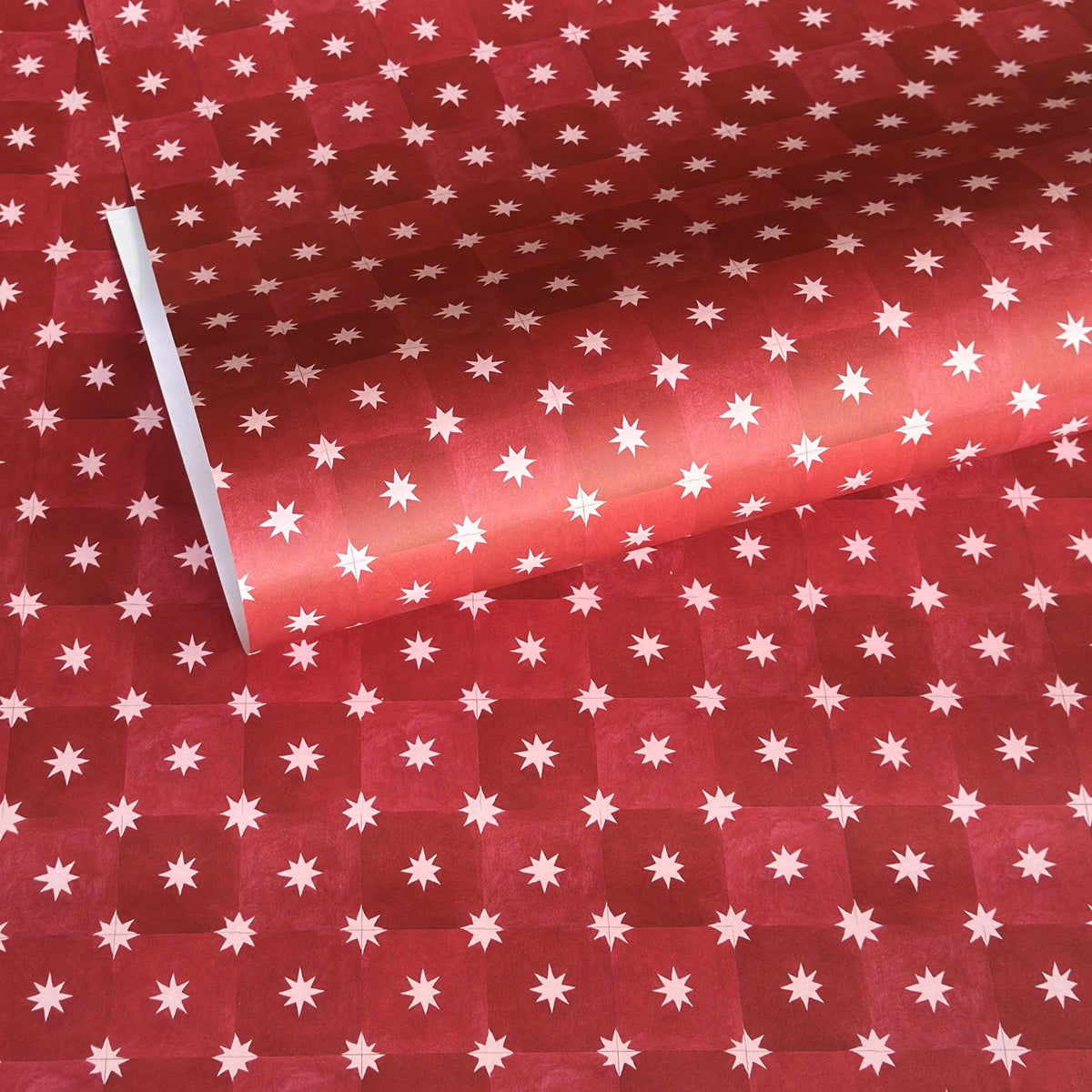 Red two-tone checked wrapping paper by Wanderlust with a white star pattern 