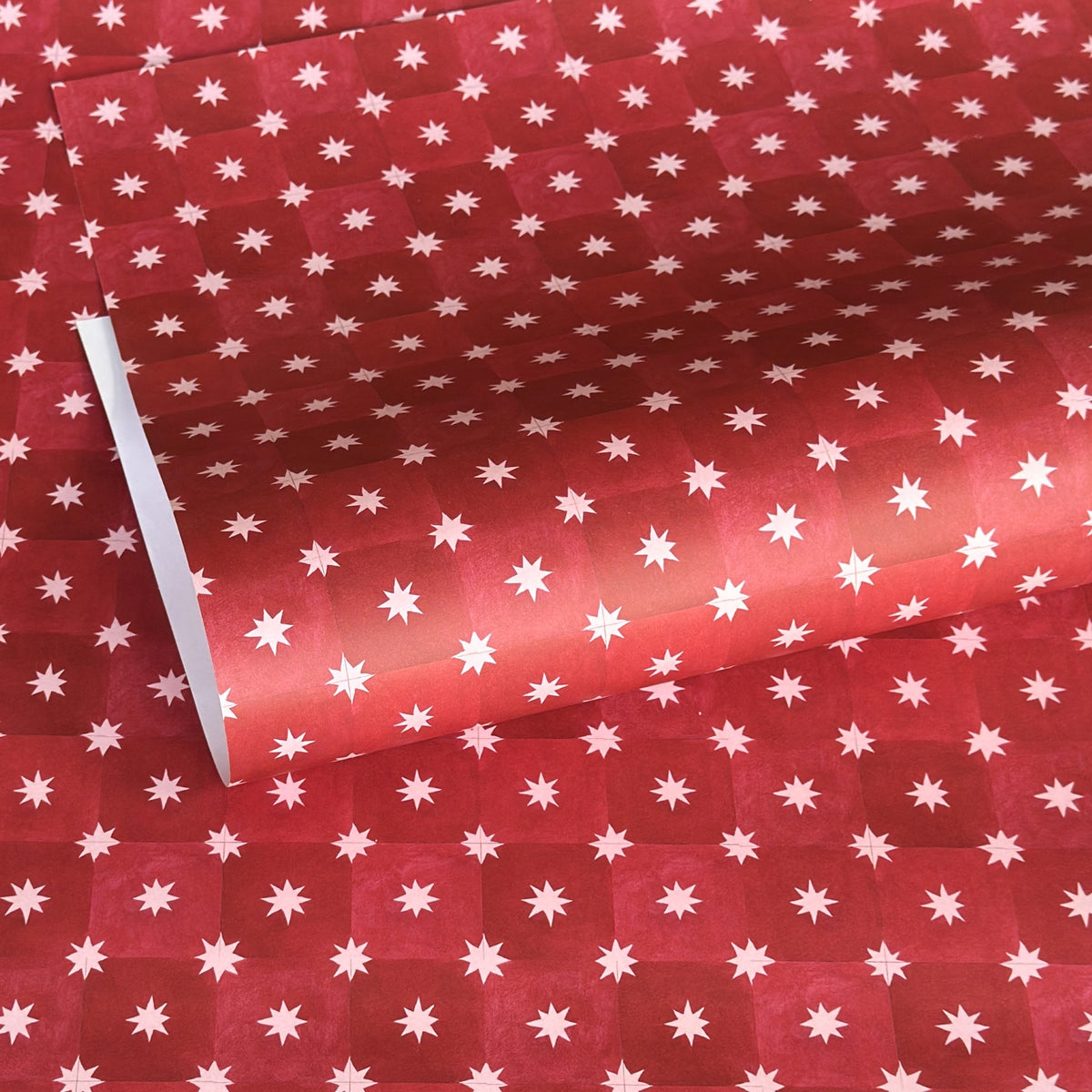 Red two-tone checked wrapping paper by Wanderlust with a white star pattern 