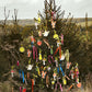 A christmas tree in the wild covered with bright decorations from Scribble and Daub. Image courtesy of Kim Lightbody