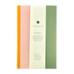 A lined notebook with striped block colours in mustard, rose and green by Amaretti Design