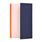 A lined notebook with striped block colours in orange, rose and navy, pictured showing the side fold that is used to protect the pages or as a place mark.