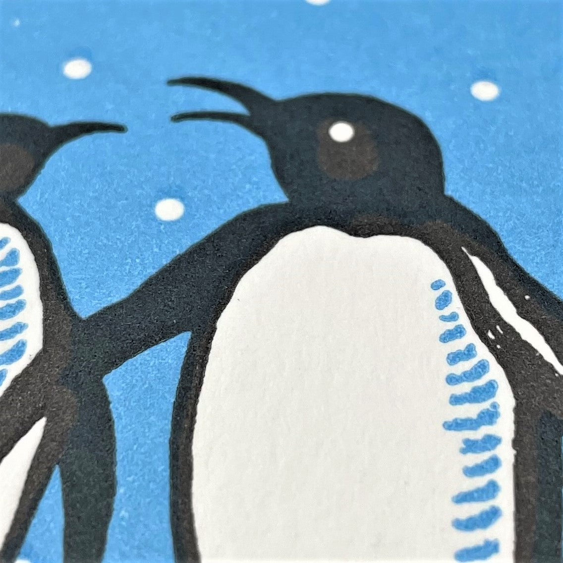 small greetings card with penguin design, close up of the card 