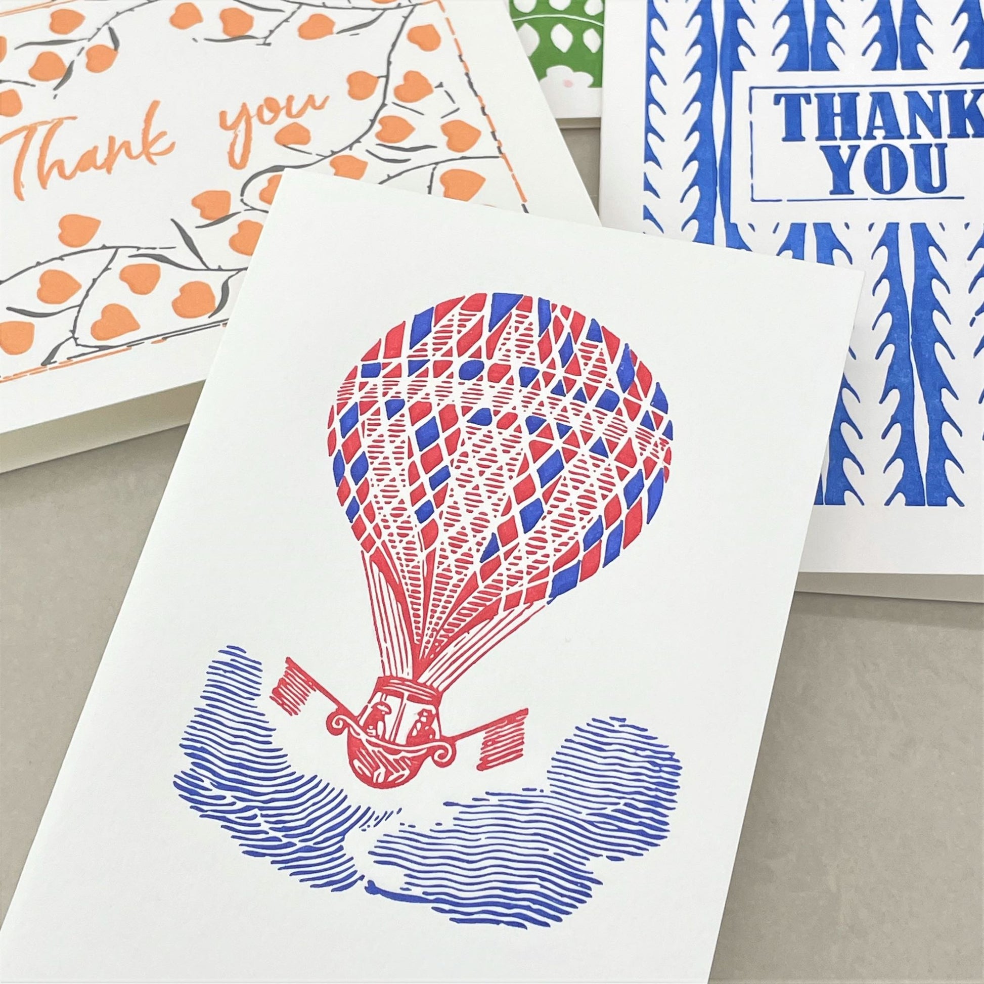 small greetings card of a red and blue hot air balloon shown with other cards