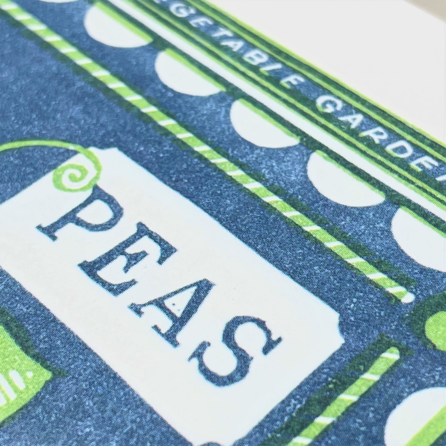 greetings card showing a blue and green vintage pack of peas, close up of the card