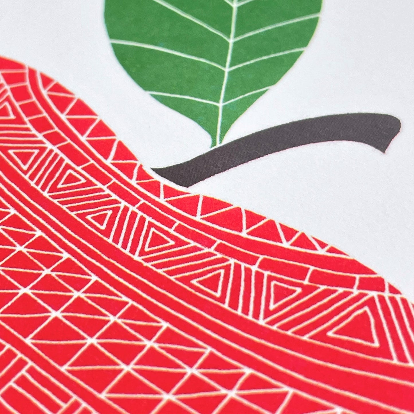 greetings card showing a patterned red apple, close up of the card