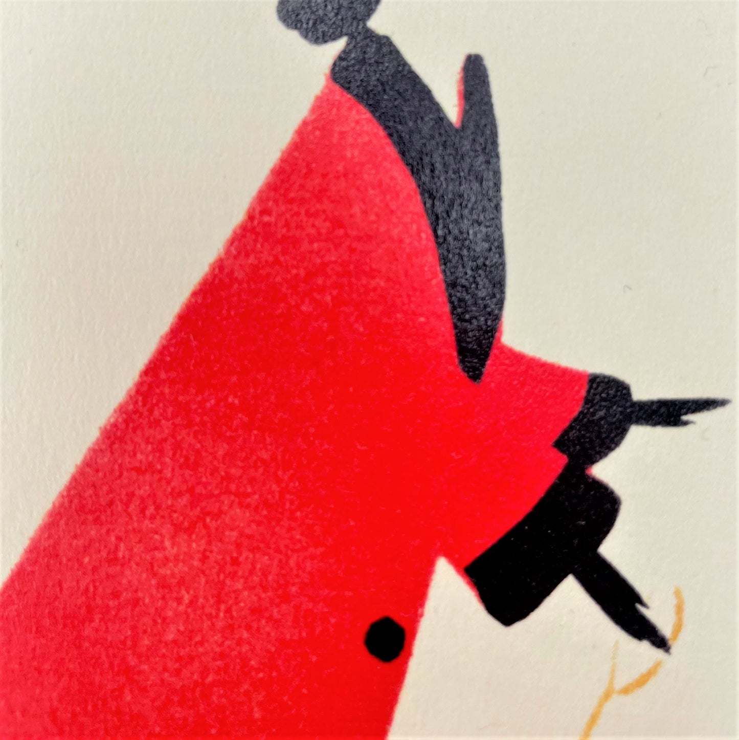 greetings card of a drawing of a women in a red coat walking a little dog, close up of the card