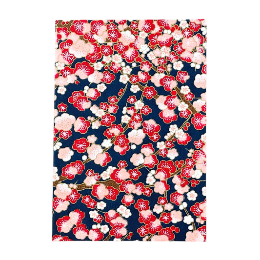 japanese silk-screen printed greetings card with a repeat pattern of pink and red blossom branches on a dark blue backdrop by Esmie