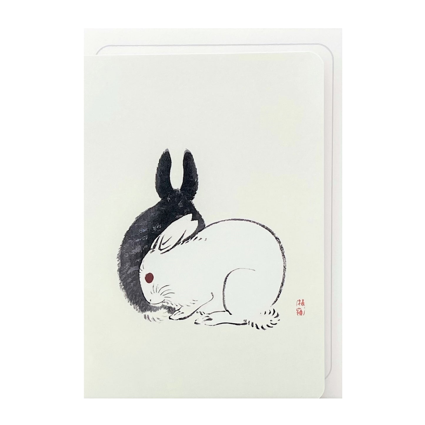 greetings card showing a drawing of one black rabbit and one white rabbit sitting together by Ezen Design