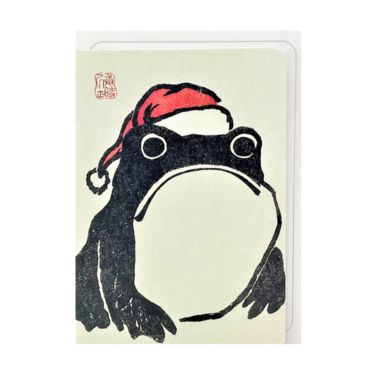 greetings card of a black japanese frog wearing a red santa hat by Ezen Design