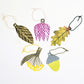 A set of five different plant shaped gift tags in colours of green, yellow and purple, with colourful string by Hadley Paper Goods