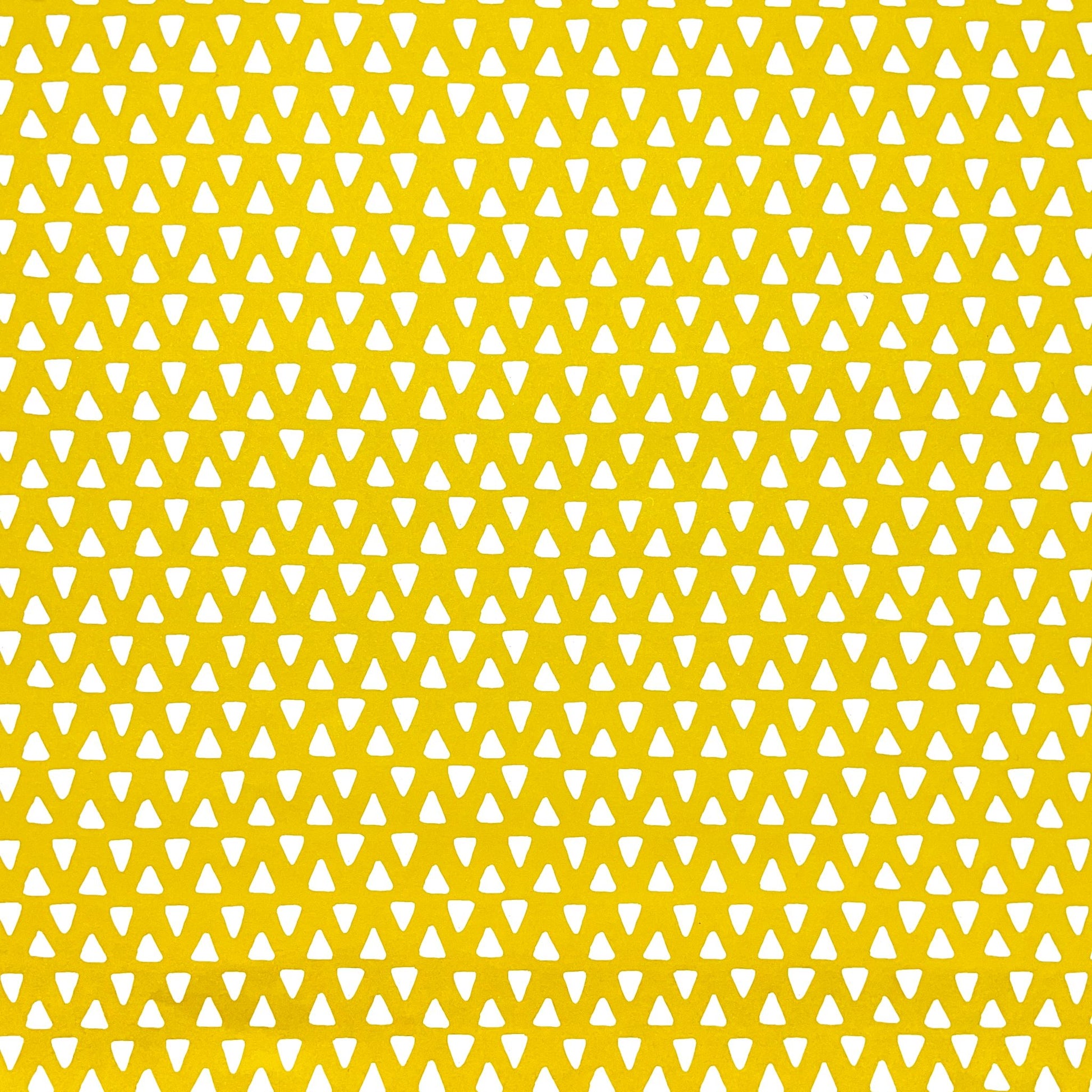 wrapping paper with yellow background and repeat pattern of little white triangles by Heather Evelyn