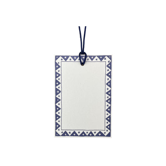 White rectangular gift tag with dark blue star pattern border and blue cord by Heather Evelyn