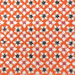 japanese stencil-dyed handmade paper with small scale floral repeat in orange and cream