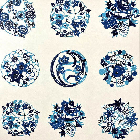 japanese stencil-dyed handmade paper with traditional blue botanical circles pattern on ivory backdrop